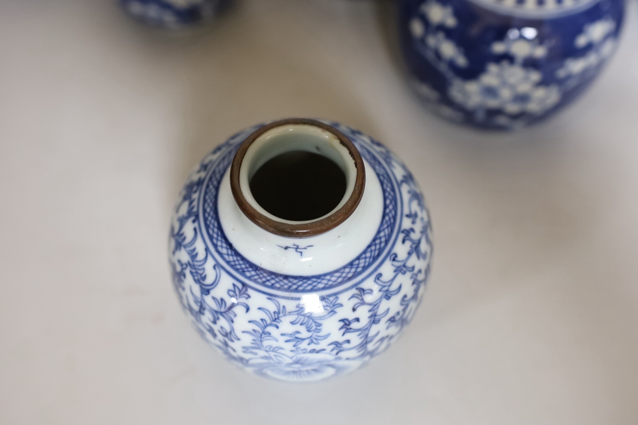 Four Chinese blue and white prunus pattern ginger jars, together with three similar vases. 19th/early 20th century, Tallest 15cm